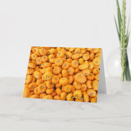 Kleine oranje herfstoogstpompoenen kaart