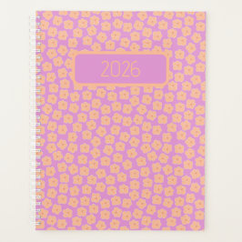 Kleine perzikbloemen op roze planner