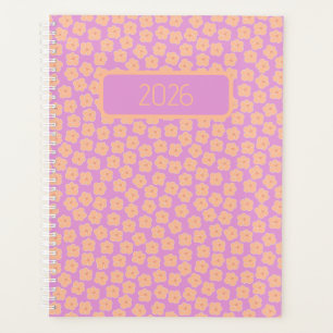 Kleine perzikbloemen op roze planner