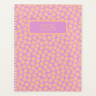 Kleine perzikbloemen op roze planner