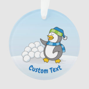 Kleine pinguïn met sneeuwballen die met ornament z