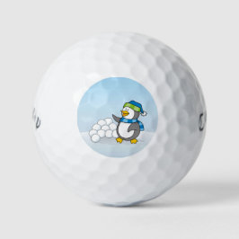 Kleine pinguïn met sneeuwballen golfballen