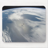 Kleine satellieten draaien boven een deel van de a muismat (Voorkant)