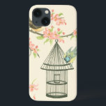 Kleine vogels op een bijkantoor en op een vogelkoo iPhone 13 hoesje<br><div class="desc">Nancy Slocum's hebben vele vogels geschilderd. Dit afbeelding beschrijft twee kleine blauwe en gele vogels die op een tak zijn geperst omringd door roze bloemen en die nieuwsgierig zijn naar een berkenkooi. Haal vandaag dit coole,  vogelvriendelijke kunstwerk op je Zazzle-product.</div>