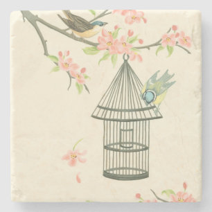 Kleine vogels op een bijkantoor en op een vogelkoo stenen onderzetter