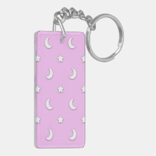 Kleine witte sterren en manen op roze sleutelhanger