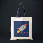 Kleurrijk raketschild, buitenruimte, voor jongens tote bag<br><div class="desc">Een schattige canvas tas voor kleine astronauten die opstaan voor een ruimteavontuur die het sterrenstelsel van planeten en sterren onderzoekt! Deze kleurrijke en aantrekkelijke tas komt met een raketschip dat de ruimte ingaat. Pas de naam van het kind aan.</div>
