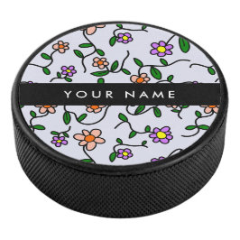 Kleurrijke bloemen, blauwe achtergrond, zwart hockey puck