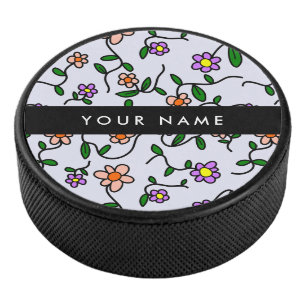 Kleurrijke bloemen, blauwe achtergrond, zwart hockey puck
