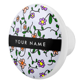 Kleurrijke bloemen, blauwe achtergrond, zwart keramische knop