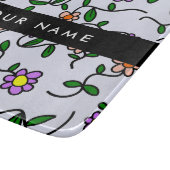 Kleurrijke bloemen, blauwe achtergrond, zwart snijplank (Hoek)