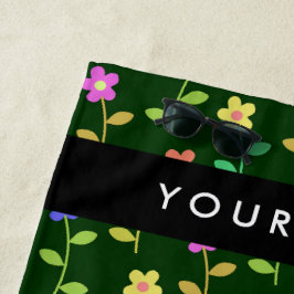 Kleurrijke bloemen, groene achtergrond, zwart strandlaken