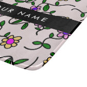 Kleurrijke bloemen, roze achtergrond, zwart snijplank (Hoek)