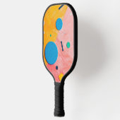 Kleurrijke cirkels op roze en geel pickleball paddle (Links)