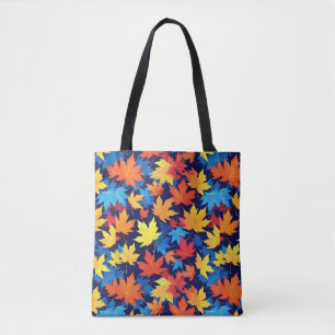 Kleurrijke herfstbladeren op donkerblauwe achtergr tote bag