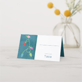 Kleurrijke kerstlichten op blauwe achtergrond plaatskaartje