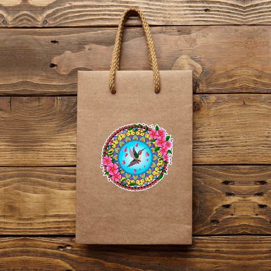 Kleurrijke mandala met een kokende vogel en roze b sticker