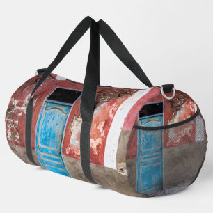 Kleurrijke muur met blauwe deur plunjezak