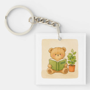 Knuffelige teddybeer leest boeksleutelhanger sleutelhanger