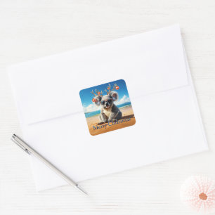 Koala op het strand met een gewei en kerstballen vierkante sticker