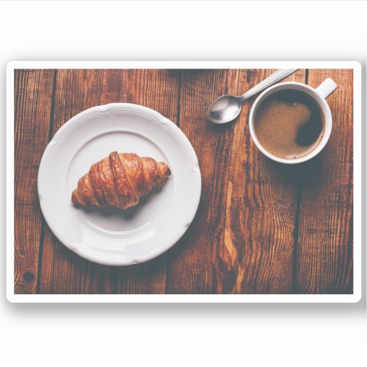 Koffiebeker en croissant op tafel sticker (Voorkant)