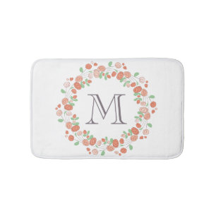 koraal roos met baarmoedermonogram badmat