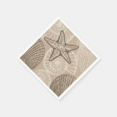 Kustzeesterren en schelpen in beige servet (Hoek)