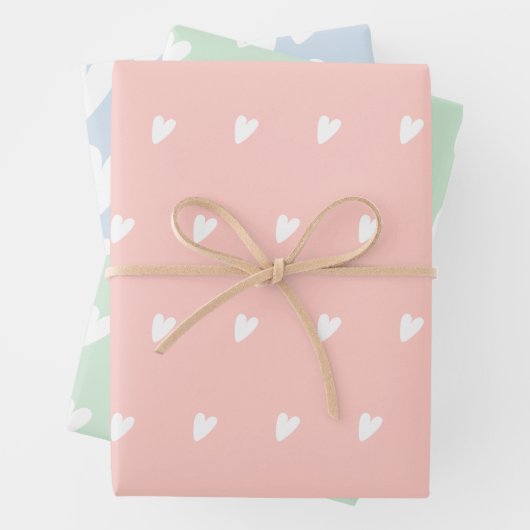 Kute roze blauwe groene harten die papierbladen ov inpakpapier vel (In situ)