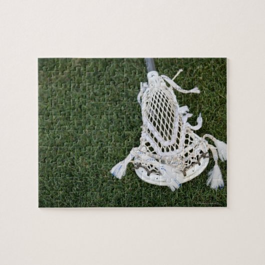 Lacrosse-stok op gras legpuzzel (Horizontaal)