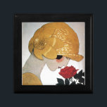LADY MET ROSE ROSE CADEAUDOOSJE<br><div class="desc">Levendige Franse illustratie met hoge mode van Art Deco. Portret van een mooie jonge vrouw met een gouden pet met bloem, zwart wit, geel, grijze kleuren .Cool, modern en artistiek design.</div>