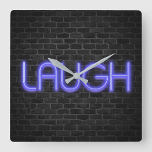 LAUGH-tekst in neonlichten op baksteen Vierkante Klok