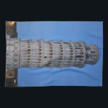 Leaning Tower at Dusk Theedoek<br><div class="desc">This captivating photograph showcases the iconic Leaning Tower of Pisa standing elegantly against a deep blue twilight sky in Pisa. The historic marble tower, famous for its unmistakable tilt, is beautifully illuminated, highlighting its intricate Romanesque arches and layered columns. The soft evening light creates a striking contrast between the glowing...</div>