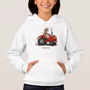 Leuke gelukkige koe die een rode tractor bestuurt 