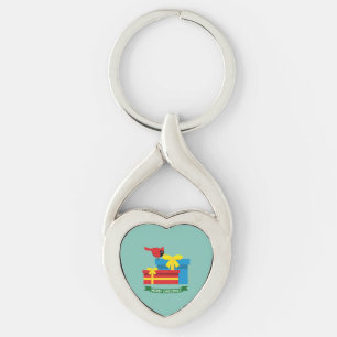 Leuke rode kardinaal die een blauw cadeau opent sleutelhanger