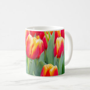 Levendige rode en gele tulpen in de lentetuin koffiemok
