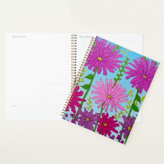 Levendige roze bloem tekening op blauw planner (Display)