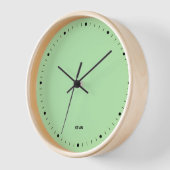 Licht groen klokgezicht en zwart aantal uren (Hoek)