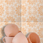 Licht Oranje Wit  Symmetrisch Geometrisch Tegeltje<br><div class="desc">Deze keramische tegel heeft een ingewikkeld ontwerp dat zowel symmetrisch als geavanceerd is. Het ontwerp kenmerkt zich door , witte bloemige en geometrische vormen die prachtig contrasteren tegen een warme, perzikkleurige achtergrond. Het ontwerp van de tegel is gecentreerd rond een diamantvormig element, omgeven door elegante wervelingen en rondingen. Dit centrale...</div>