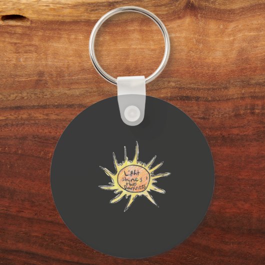 Licht schijnt door de duisternis sleutelhanger (Voorkant)