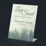 Liefde is Sweet Foggy Green Pines Rustic Wedding Reclamebord Met Voetstuk<br><div class="desc">Dit mooie voetstuk is perfect voor een tafel bij je trouwreceptie. In het luxe ontwerp in de openlucht bevindt zich een bergachtige zijde die bedekt is met groene evergroene of pijnse bomen en die in mist of nevel is gehuld. De elegante manuscripttekst leest "de Liefde is lief te nemen gelieve...</div>