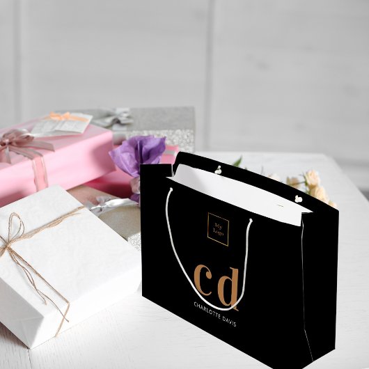 Logo zwarte goudmonogram initialen winkelen groot cadeauzakje