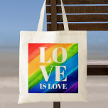 Love is love Pride Tote Bag<br><div class="desc">Deze Pride Canvas tas is versierd met LOVE IS LOVE in vetgedrukte witte letters op een waterverf regenboogachtergrond van rood,  oranje,  geel,  groen,  blauw en paars. Oorspronkelijke Waterverf © Michele Davies.</div>