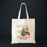 Love Yourself This Christmas Cute Cat Holiday Tote Bag<br><div class="desc">Spread a message of self-love this holiday season with this charming Christmas cat. Featuring a festive kitty in a Santa outfit perched by a decorated tree, this design serves as a gentle reminder to prioritize your own well-being during the holidays. A sweet and meaningful choice for cat lovers and anyone...</div>