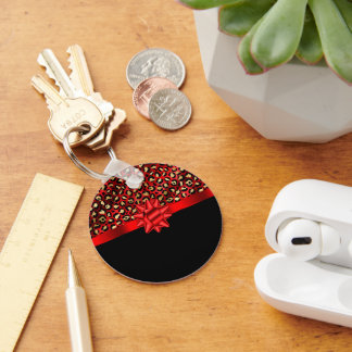 Luipaardprint rood, goud en zwart met rode strik sleutelhanger