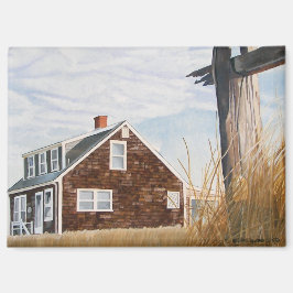 Magneet met strandhuis bij zonsopgang