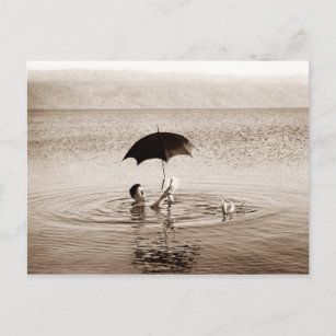 Man lezen onder paraplu in het dode Zee Briefkaart
