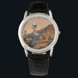 Mars Science Laboratory Curiosity Rover. Horloge<br><div class="desc">Het concept van Mars Science Laboratory Curiosity rover is een mobiele robot die het cadeau van Mars onderzoekt. In dit afbeelding onderzoekt de rover een rots op Mars met een set gereedschappen aan het uiteinde van de arm van de rover, die ongeveer 7 voet uitstrekt. Twee instrumenten op de arm...</div>