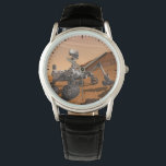 Mars Science Laboratory Curiosity Rover. Horloge<br><div class="desc">Het concept van Mars Science Laboratory Curiosity rover is een mobiele robot die het cadeau van Mars onderzoekt. In dit afbeelding onderzoekt de rover een rots op Mars met een set gereedschappen aan het uiteinde van de arm van de rover, die ongeveer 7 voet uitstrekt. Twee instrumenten op de arm...</div>