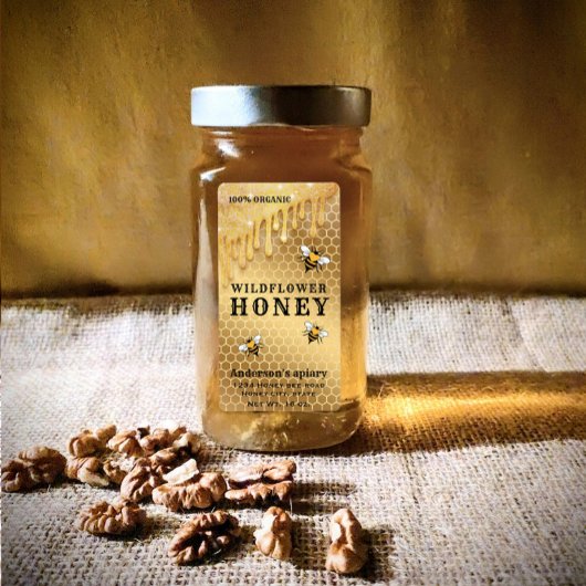 Matig druppelt gouden bijenhoningpot op etiket