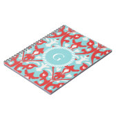 Matig monogram van het rode ikattribaal notitieboek (Linkerzijde)